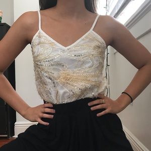 textured white top w/ gold and feather details